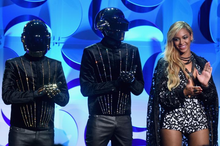 Beyonce sports a smile next to Daft Punk.