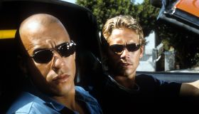 Vin Diesel and Paul Walker looking from car in a scene from the film 'The Fast And The Furious', 2001.