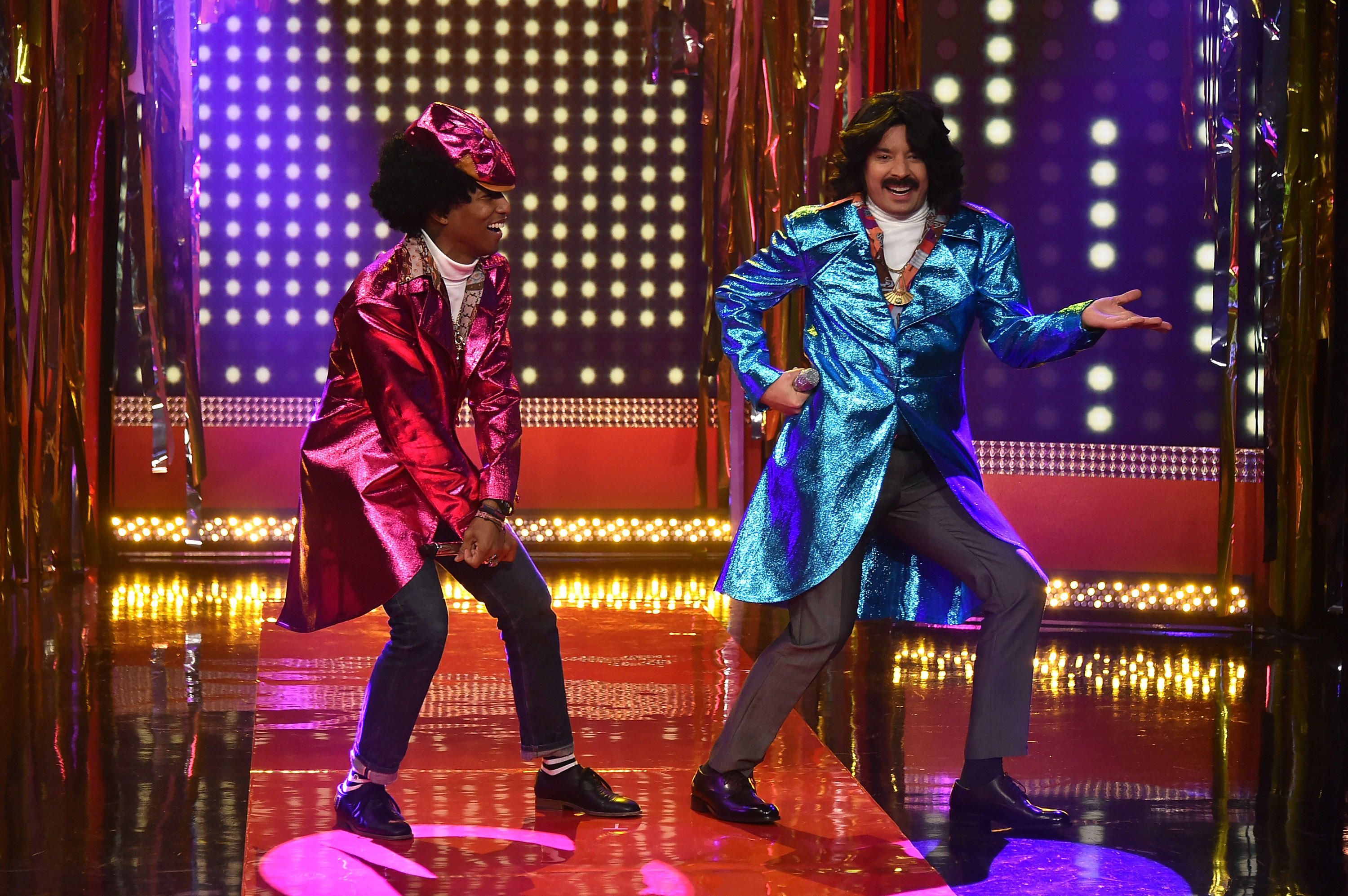 Jimmy Fallon and Pharrell hit the stage and put on a show in colorful costumes.