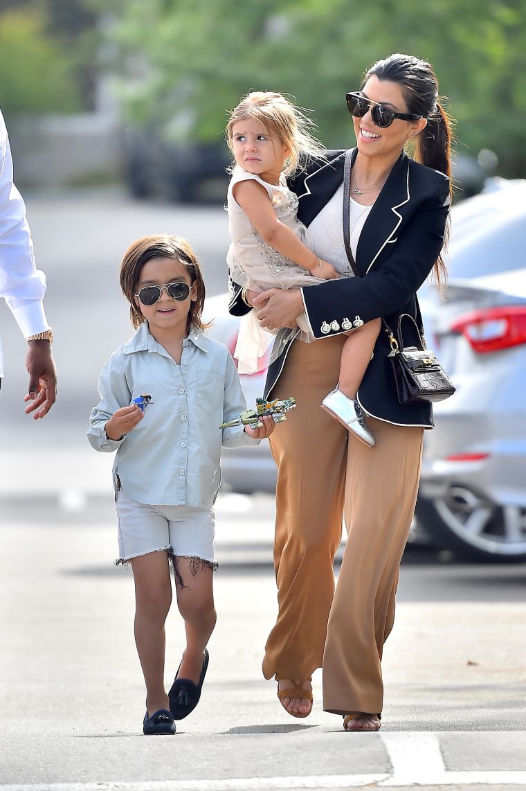 Kourtney carried Penelope as Mason kept it casual while heading into church.