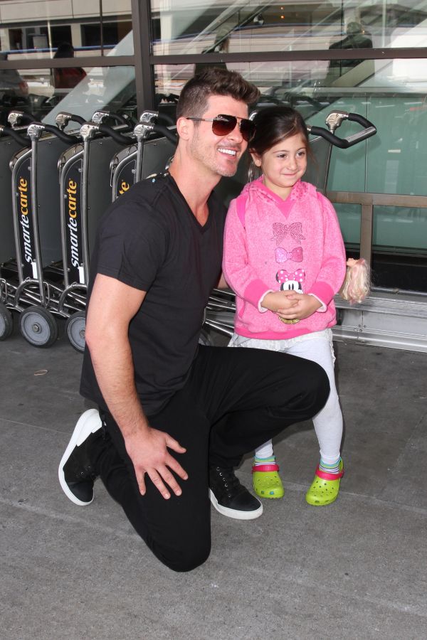 Robin Thicke greets some young eager female fans as he arrives in Los Angeles.