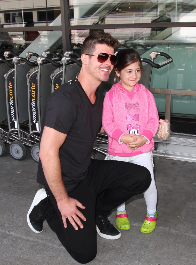 Robin Thicke greets young fans as he arrives in Los Angeles.