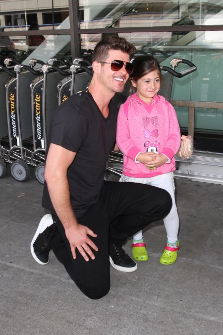 Robin Thicke greets young fans as he arrives in Los Angeles.