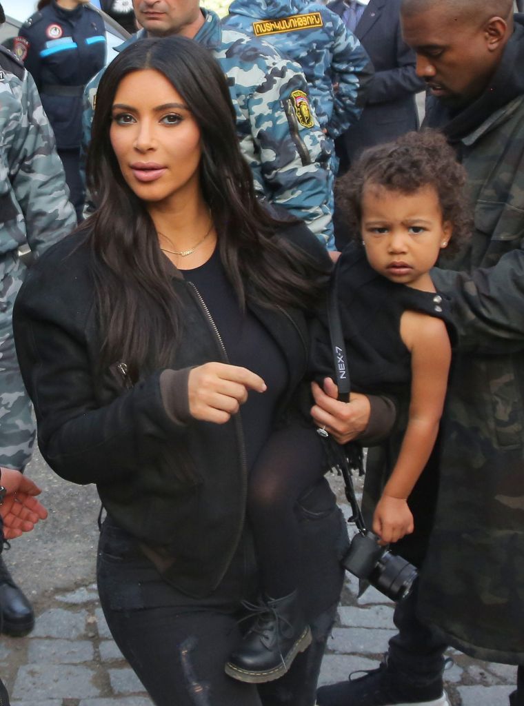 Kim carried North around on her hip throughout the day.