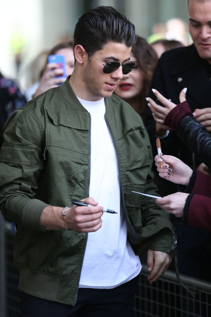 Nick Jonas greets fans as he leaves BBC Radio 1 in London.