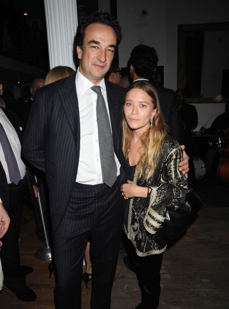 Mary Kate Olsen and her fiancé Olivier Sarkozy cuddle in close for a photo at the 2015 Tribeca Ball in NYC.