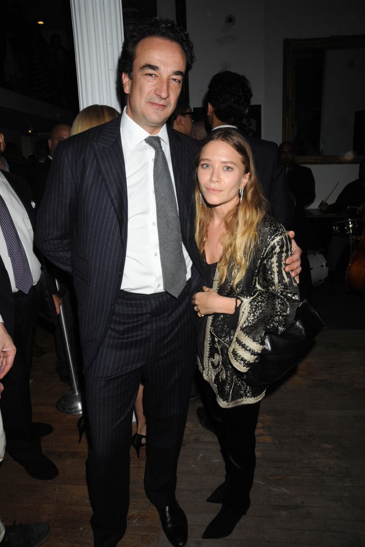 Mary Kate Olsen and her fiancé Olivier Sarkozy cuddle in close for a photo at the 2015 Tribeca Ball in NYC.
