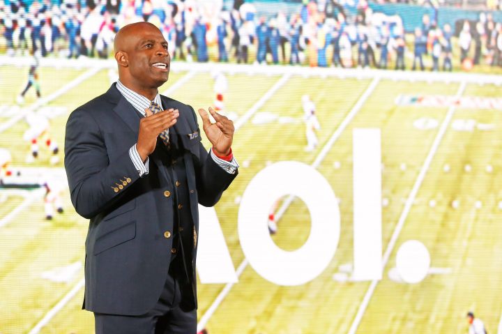 Neon Deion Sanders can pitch anything! Here he is during the AOL 2015 Newfront in New York City.