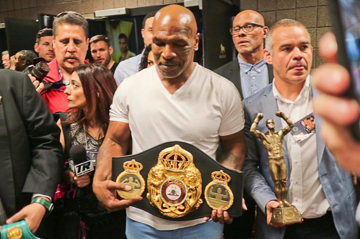 Mike Tyson shows off WBA belt during Mayweather/Pacquiao weigh-in.