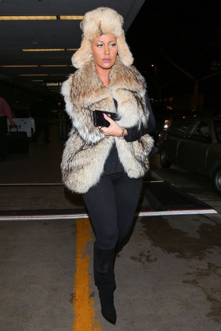 Amber Rose landed at LAX ready for winter in May as she rocked fur from her head to booty.