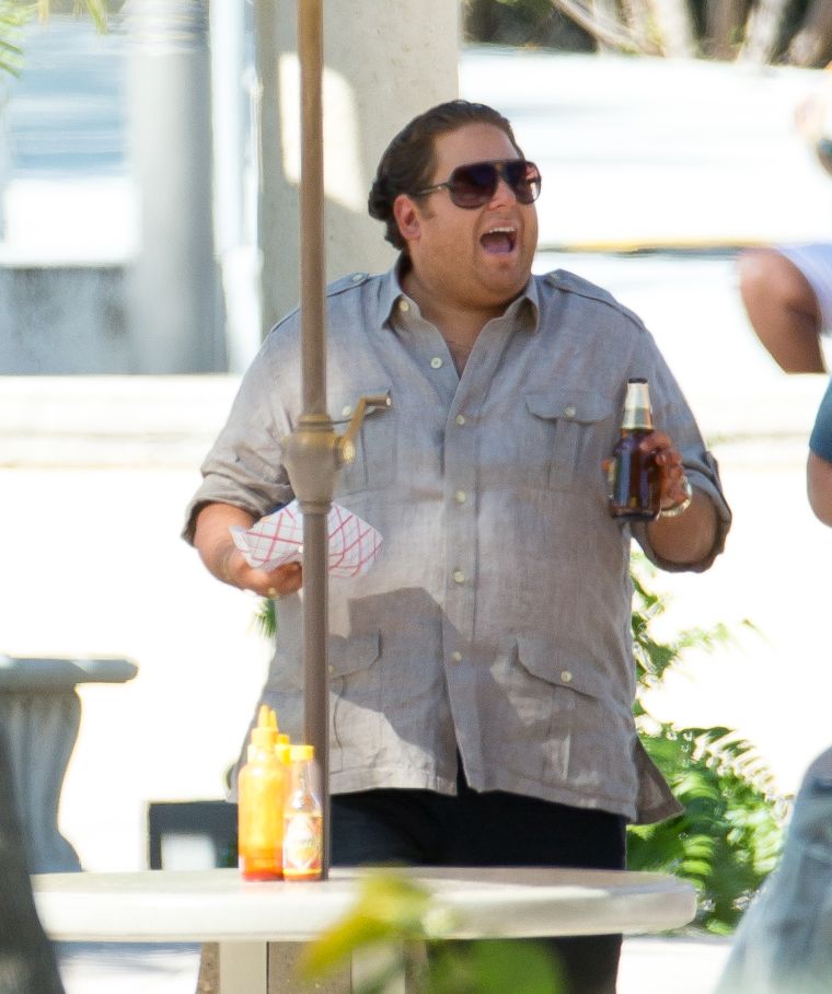 Jonah Hill is making big moves as he sips on a beer and eats some food on set of his new film with Miles Teller called “Arms and the Dudes.”