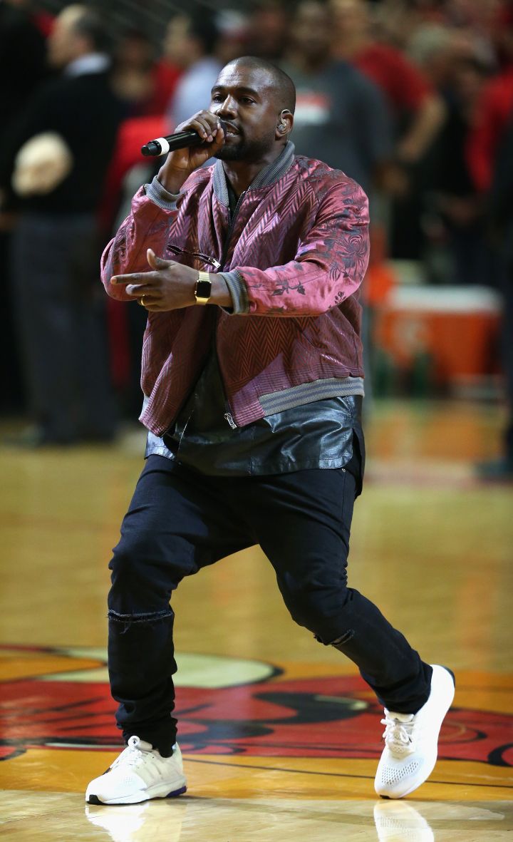 Kanye West rocks a gold apple watch during a halftime performance.
