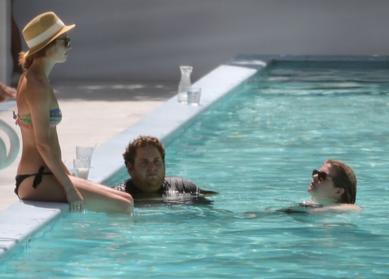 Jonah Hill is having a great time with some female company as he takes a dip in the pool at his hotel in Miami Beach.