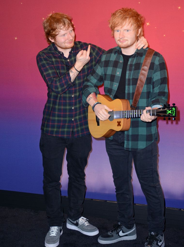 Ed Sheeran poses next to his new wax figure at Madam Tussauds.