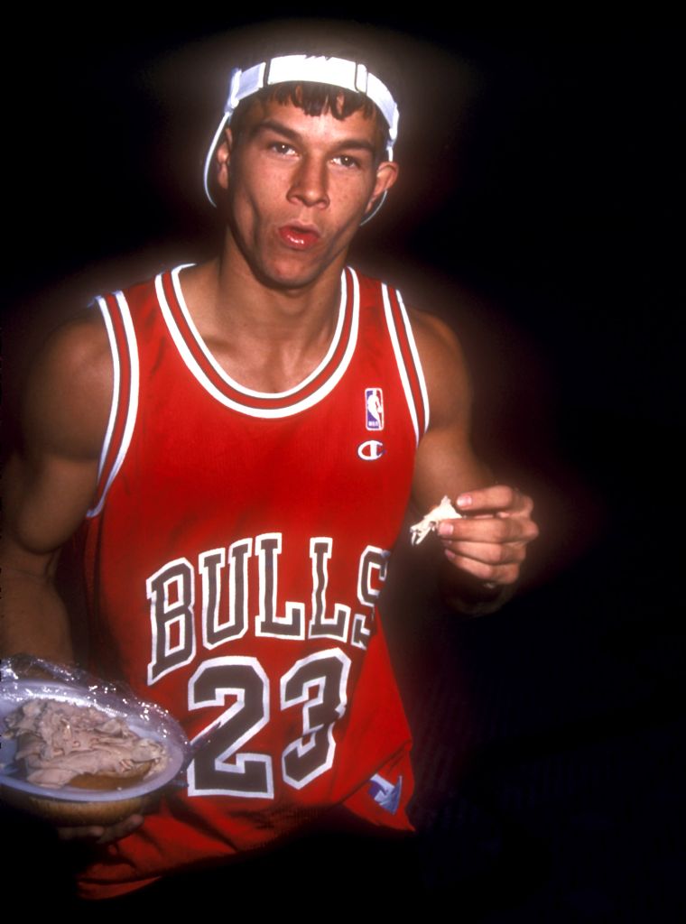 Mark Wahlberg used to be a rapper by the name of Marky Mark. Here he is eating chicken.