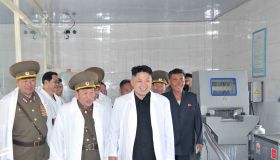 North Korean leader Kim Jong Un (C) inspecting a pig farm 2013