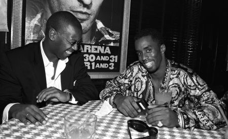 Diddy all laughs next to Andre Harrell.