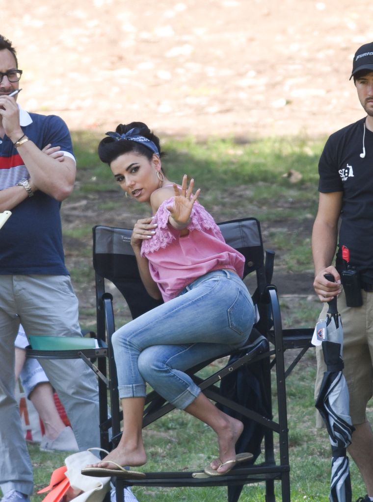 Eva Longoria acts out a part while sitting down on the set of "Low Riders."
