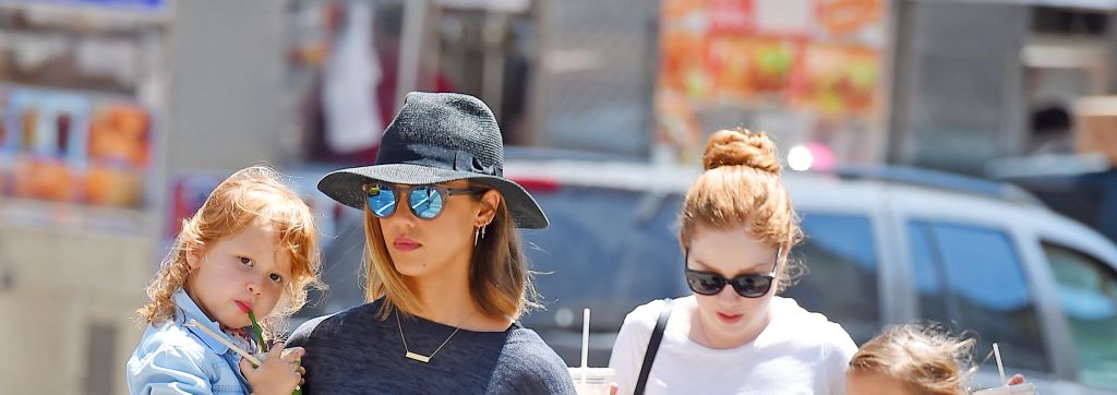 Jessica Alba carries daughter Haven in her arms as her other daughter Honor walks by