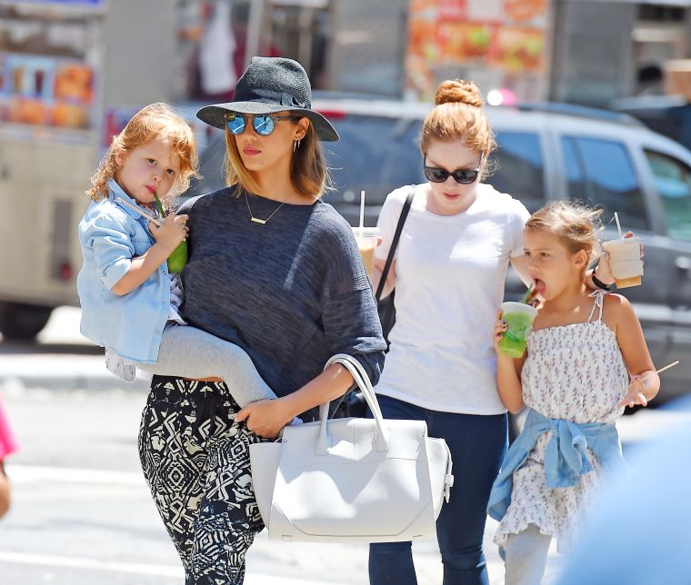 Businesswoman Jessica Alba holds daughter Haven in her arms, while Honor follows closely behind.