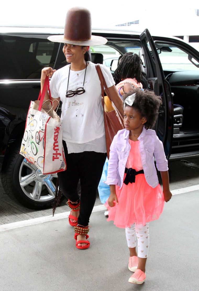 Erykah Badu keeps a smile on her face while traveling with her family in L.A.