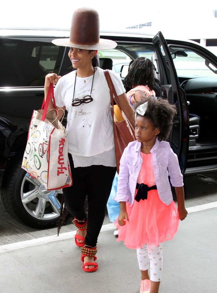 Erykah Badu keeps a smile on her face while traveling with her family in L.A.