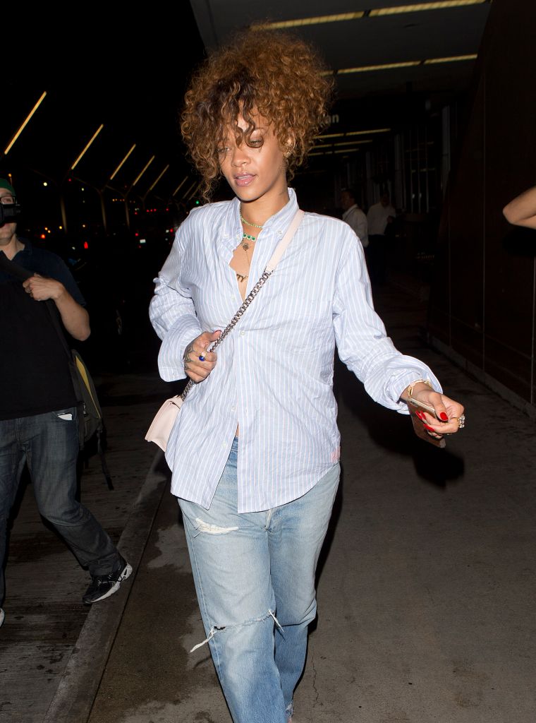 Rihanna was spotted wearing pink fluffy high heel shoes and jeans while arriving at LAX on a flight from New York City.