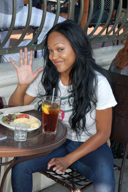 A baby-faced Meagan waves hello to the paparazzi while eating lunch.