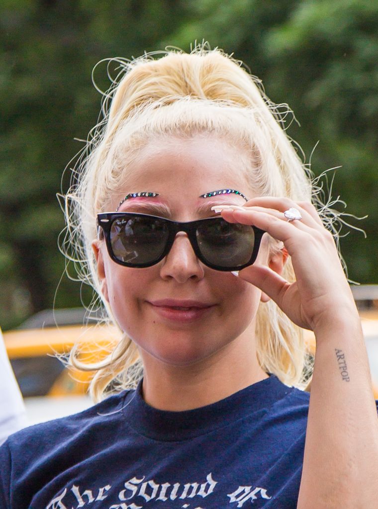 Lady Gaga rocks studded eyebrows while greeting fans in New York City.