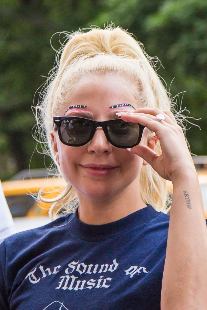 Lady Gaga rocks studded eyebrows while greeting fans in New York City.