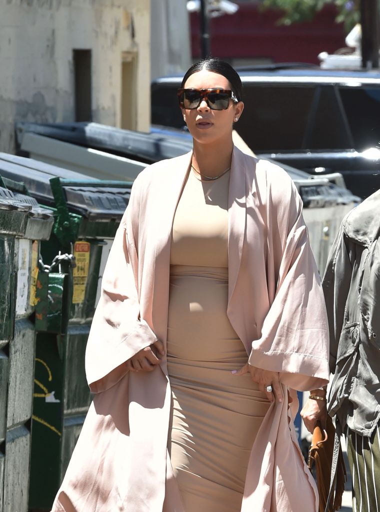 Kim K showed off her ever growing belly as she headed to the Pantages Theater in Hollywood.