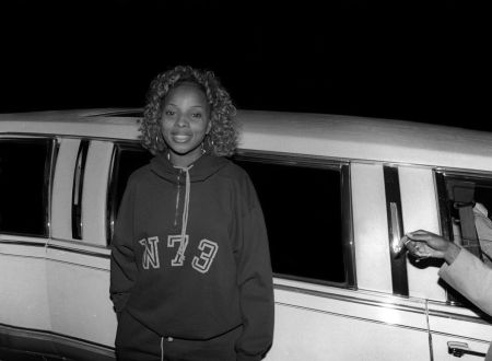 Mary J. Blige is all smiles in a hoodie and curls.