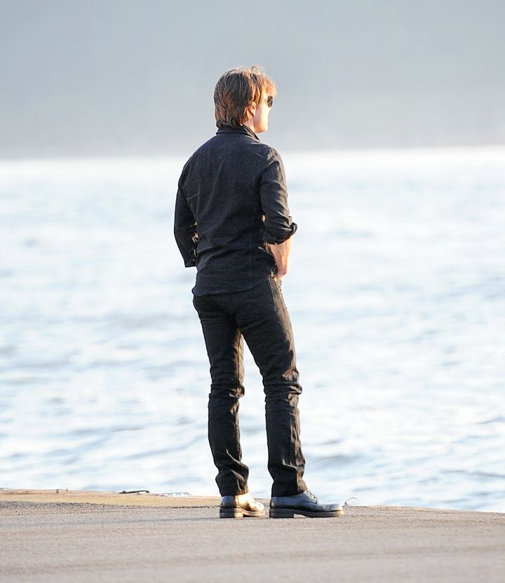 Tom Cruise stares at the sunset on the bank of the Hudson River. Deep.