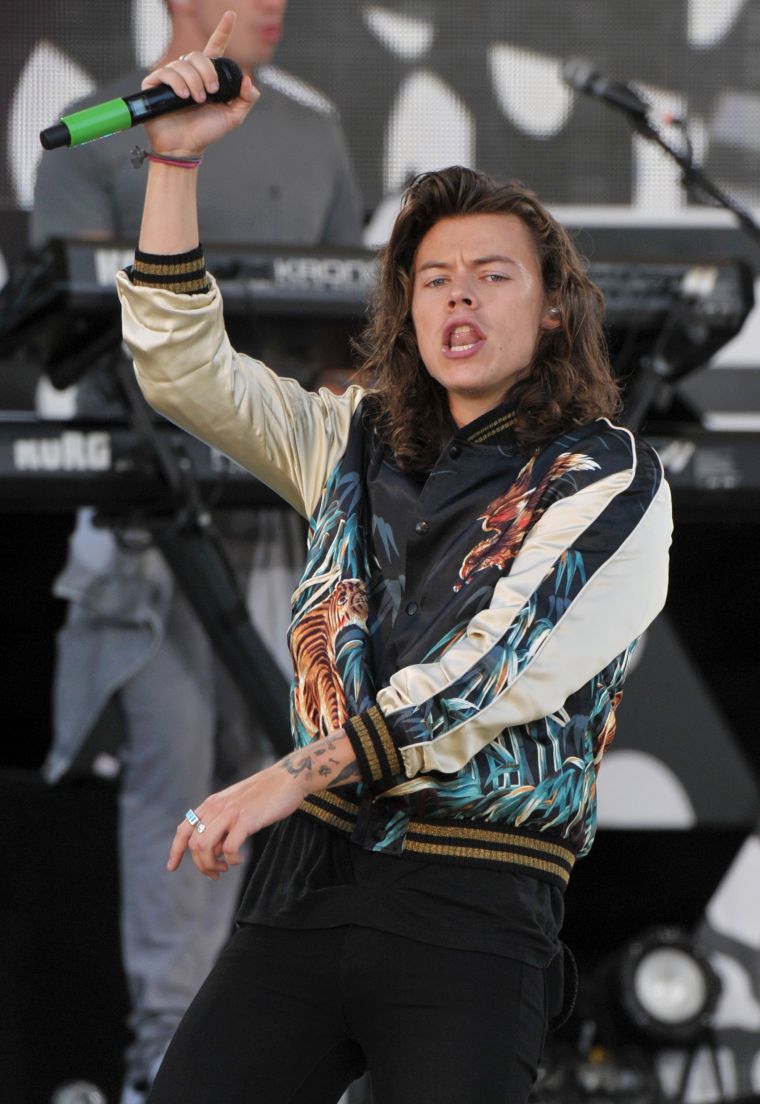 Harry Styles is turnt up in a silk bomber jacket at a recent One Direction concert.