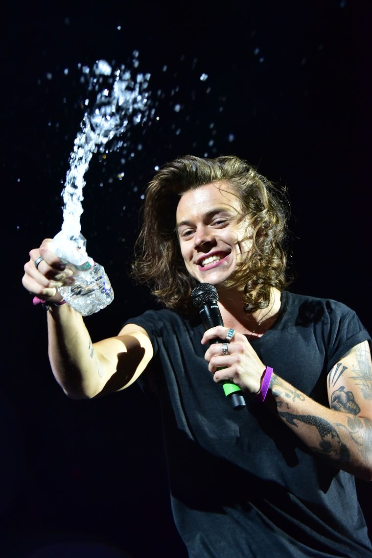 One Direction’s Harry Styles splashes water on some eager fans who were so turnt up by the group’s performance at MetLife Stadium, that people reported hearing screaming all the way to the turnpike.