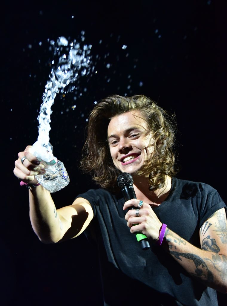 One Direction's Harry Styles splashes water on some eager fans who were so turnt up by the group's performance at MetLife Stadium, that people reported hearing screaming all the way to the turnpike.