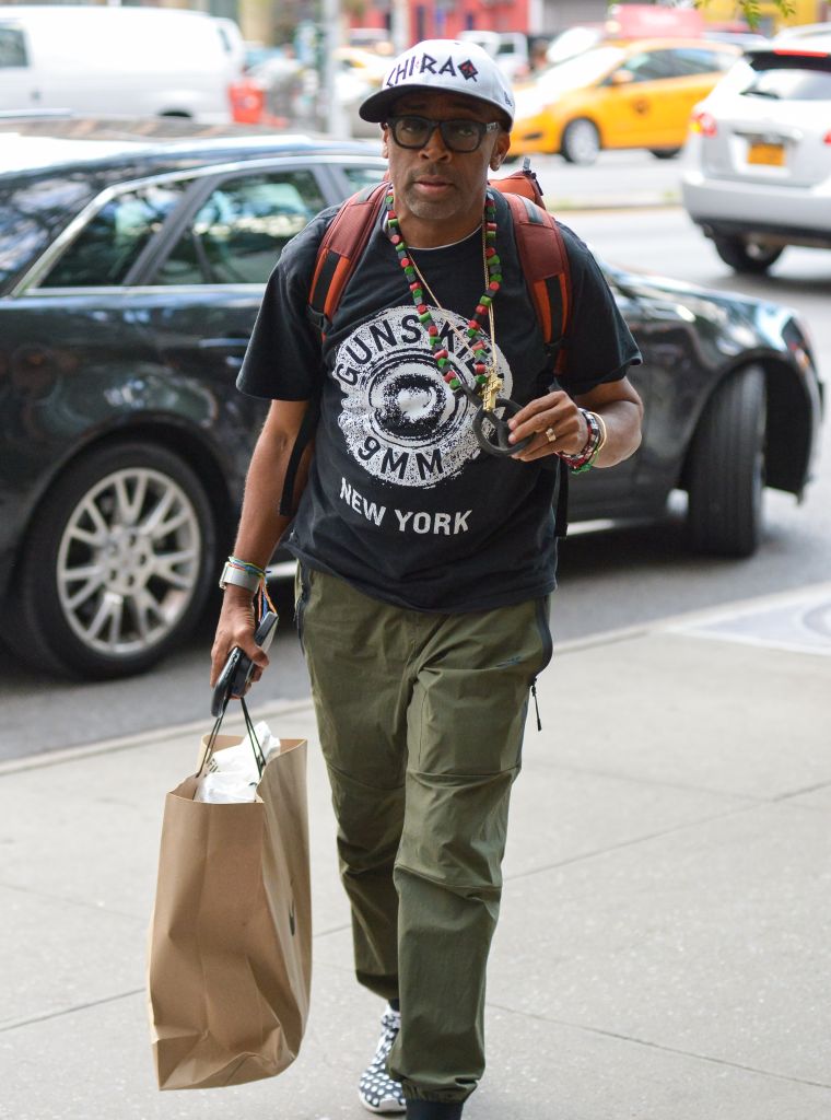 Spike Lee is always willing to make a statement. Here he is holding up his peace sign necklace while wearing a "Guns Kill" t-shirt in downtown Manhattan.