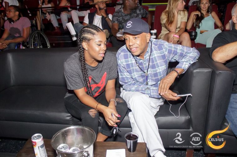 Russell Simmons and Miss Diddy take a second to catch up.