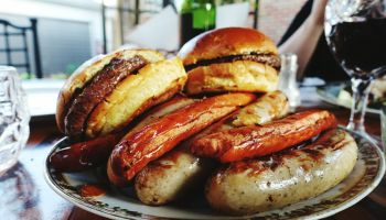 Hamburgers And Sausages On Plate