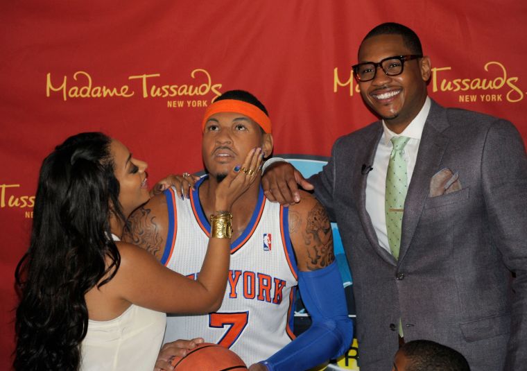 La La kisses Carmelo’s wax figure.