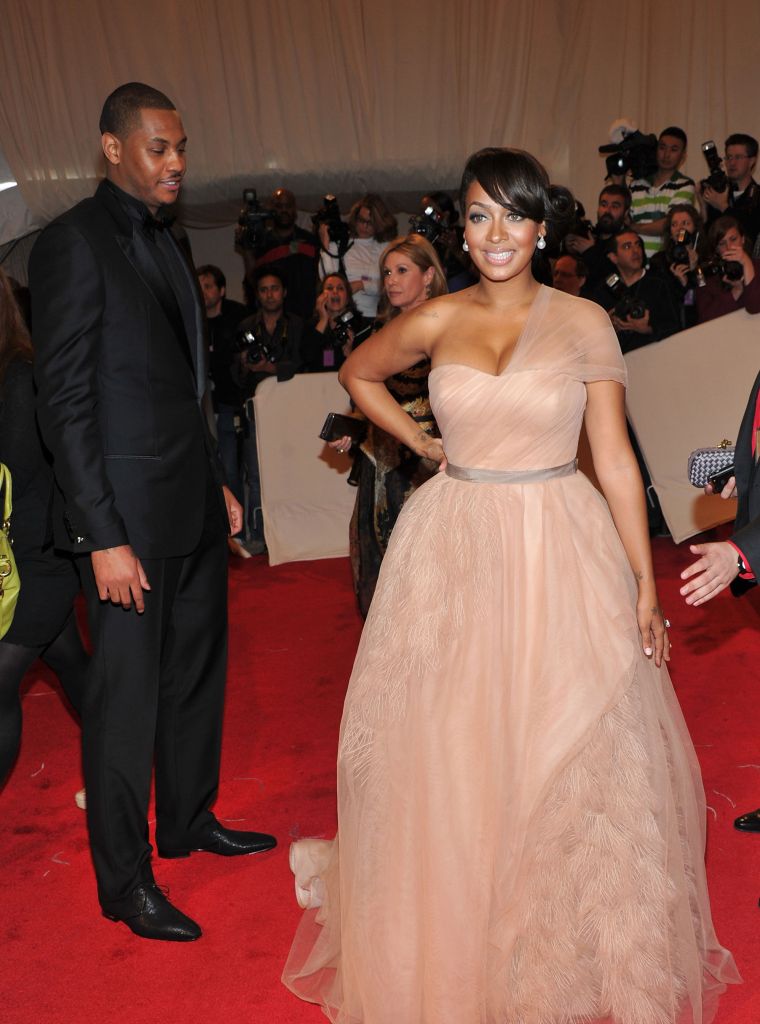 Melo admires his wife as she slays the red carpet.