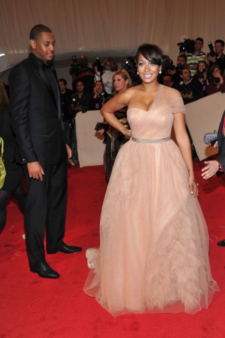 Melo admires his wife as she slays the red carpet.