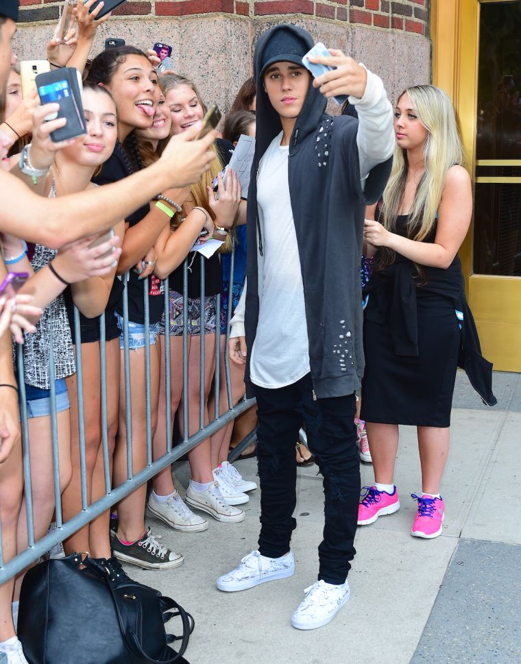 A casually dressed Justin Bieber took dozens of selfies with screaming fans who waited overnight outside Z100 to see the mega pop star.