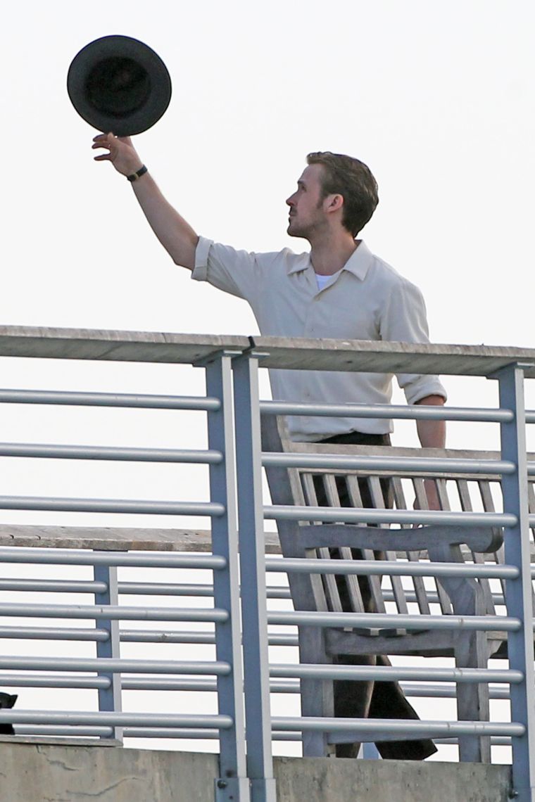 Ryan Gosling pulls off a sick hat trick as he filmed a scene on a Los Angeles pier for his latest movie, “La La Land.”