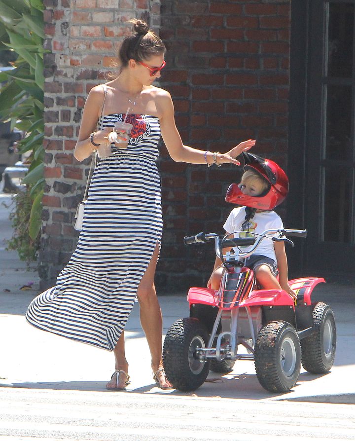 Alessandra Ambrosio takes hold of son Noah’s quadbike as he races along the streets of Brentwood.