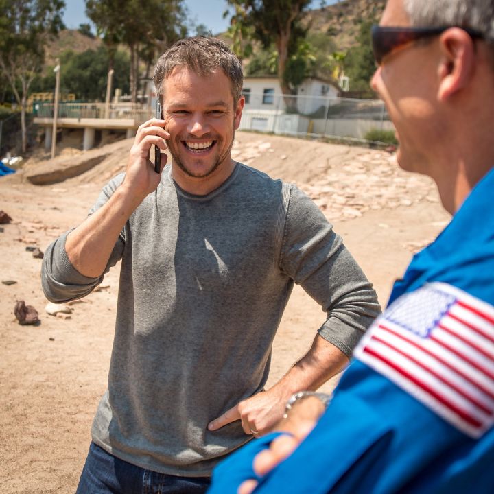 Actor Matt Damon, who stars as NASA Astronaut Mark Watney in the film “The Martian,” talks on the phone with NASA Astronauts Scott Kelly and Kjell Lindgren, who are currently onboard the International Space Station.