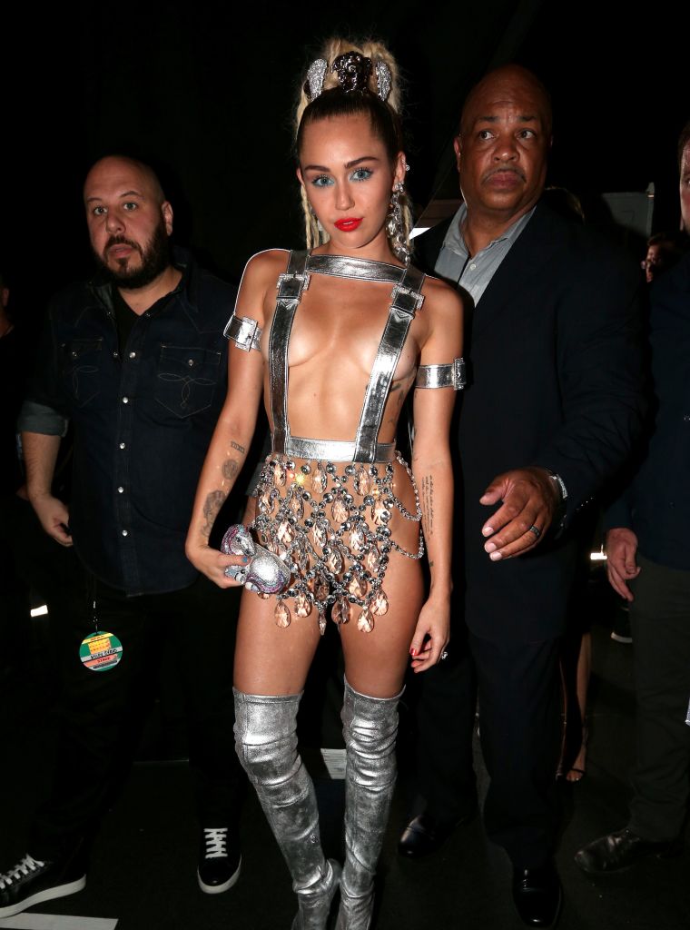 Miley Cyrus narrowly avoids nip-slips in Versace.