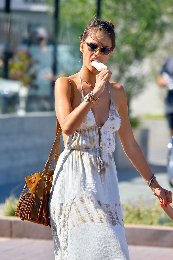 She bites! Alessandra Ambrosio has a popsicle while out with her son and husband.