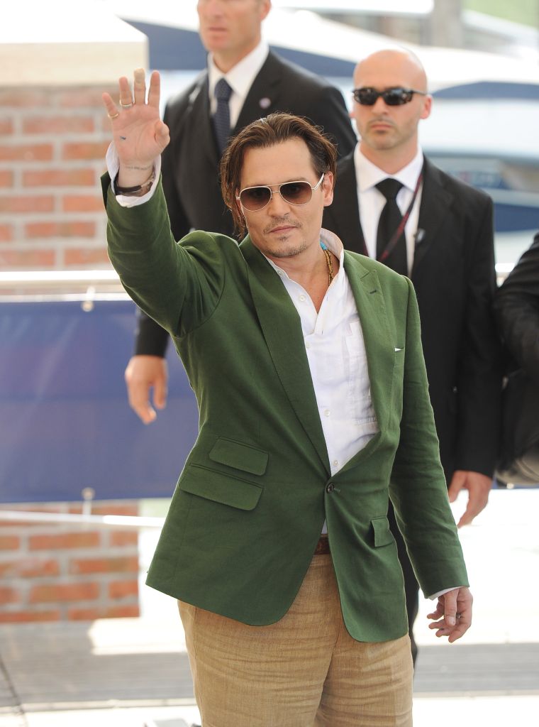 "Black Mass" star Johnny Depp waved to screaming fans at the 72nd Venice Film Festival.