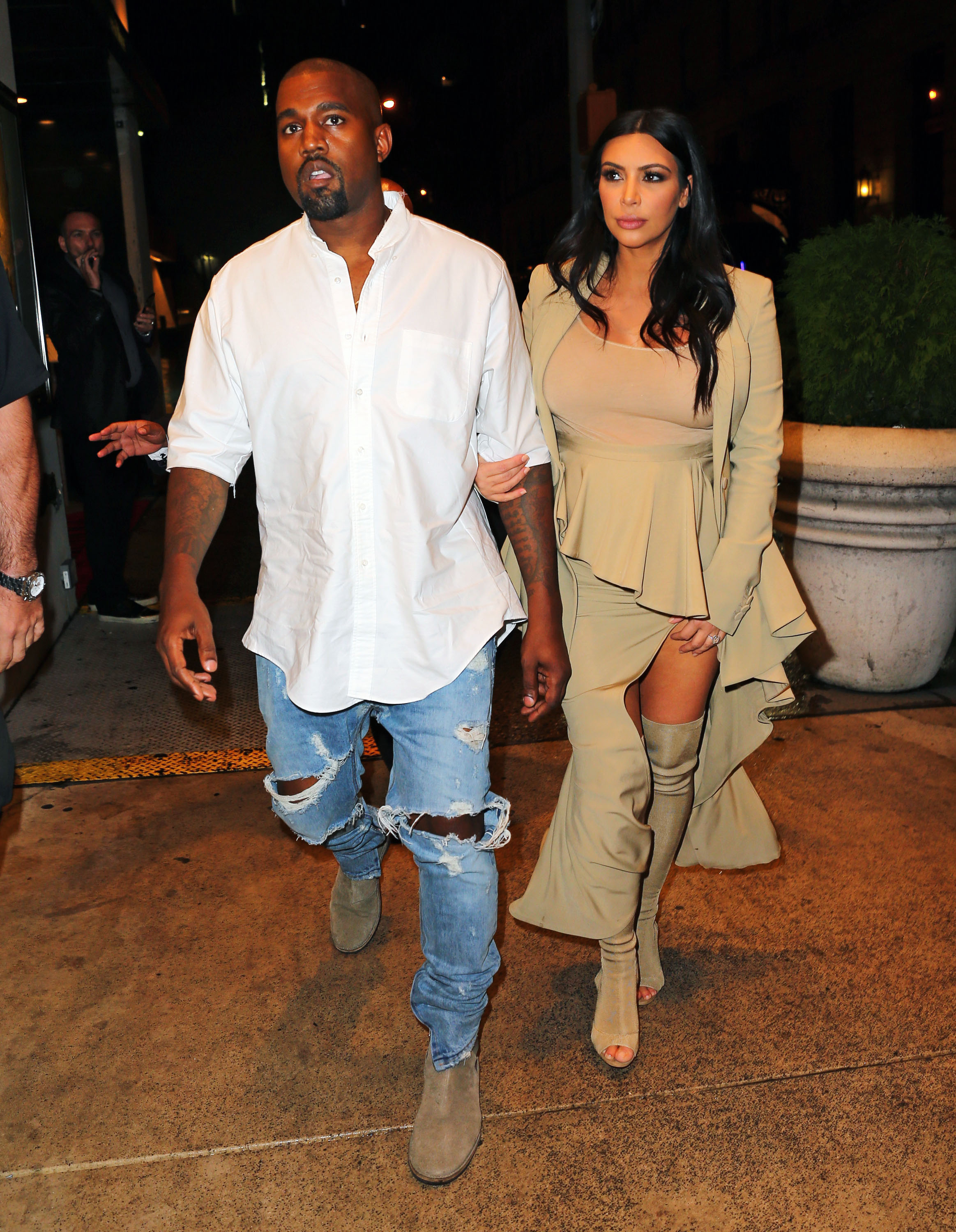 Kanye West and Kim Kardashian go to dinner in the rain in Midtown